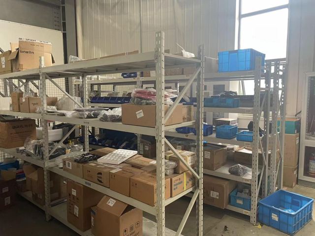 Conventional material shelving before an NVMI-H installation at a robotics industry site